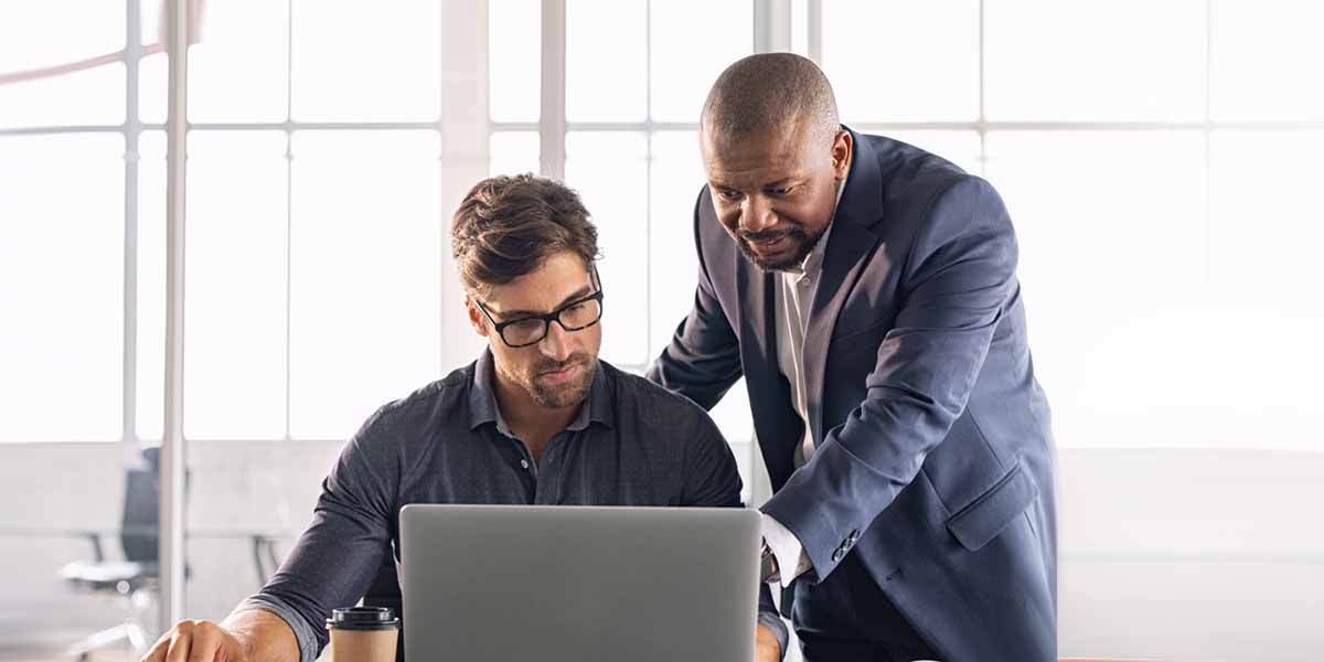 men working on laptop