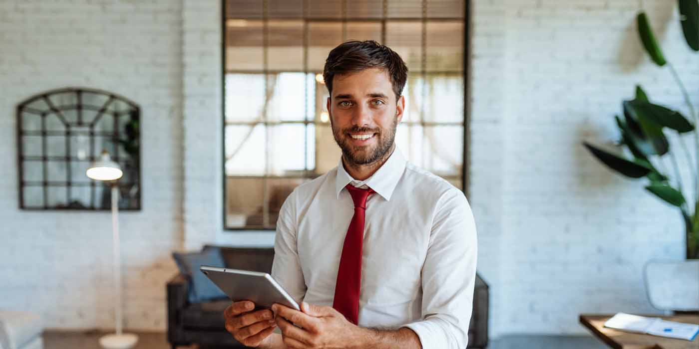 smiling man with tablet