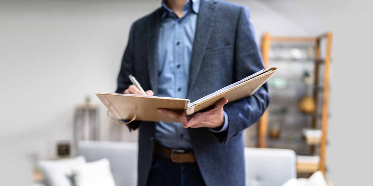 man writing in notebook